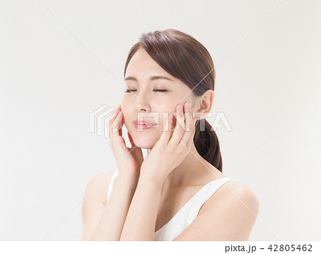 ビューティイメージ 頬に手を添える女性の写真素材