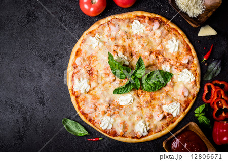 Pizza with seafood shrimps, salmon and ingredients 42806671
