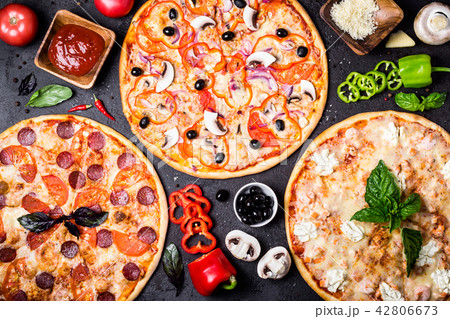 Pizzas on a black background and ingredients. Pizzas on a black background and ingredients. 42806673