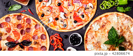 Pizzas on a black background and ingredients. Pizzas on a black background and ingredients. 42806674