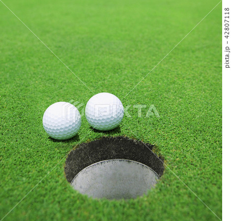 The balls at the hole on the golf course The balls at the hole on the golf course 42807118