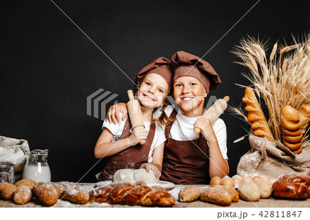 Adorable girl with brother cooking 42811847