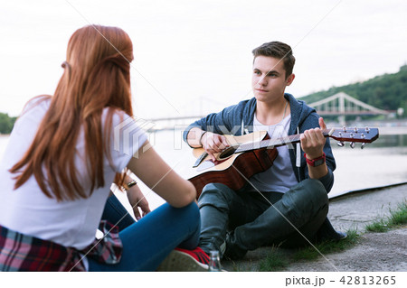 Pleasant nice man holding the guitar Romantic date. Pleasant nice man holding the guitar Romantic date. 42813265