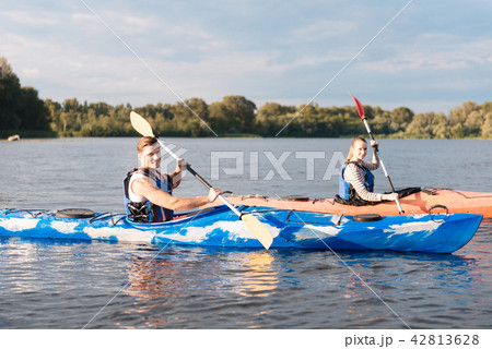 Modern active couple wearing life vests caring about safety Modern active couple wearing life vests caring about safety 42813628