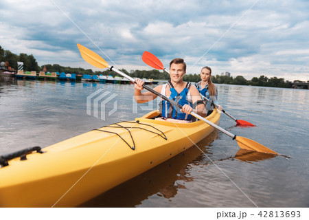 Young sport couple kayaking in the river outside the city 42813693