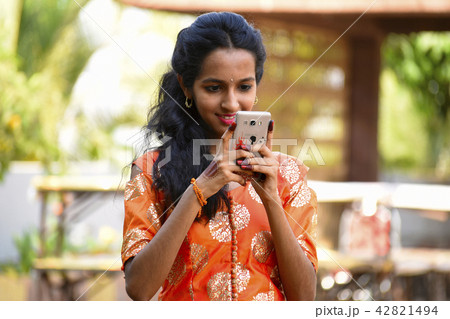 Young girl looking at her mobile, Pune 42821494