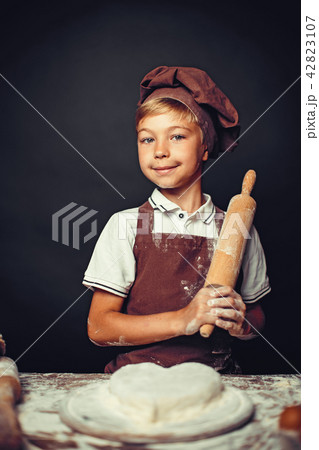 cute little boy with chef hat cooking cute little boy with chef hat cooking 42823107