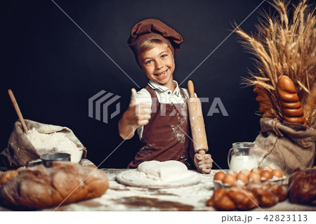 cute little boy with chef hat cooking 42823113