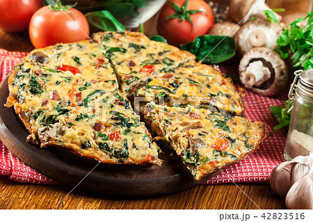 Frittata made of eggs, mushrooms and spinach Frittata made of eggs, mushrooms and spinach 42823516