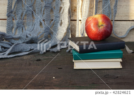 Apple on pile of books at the  table 42824621