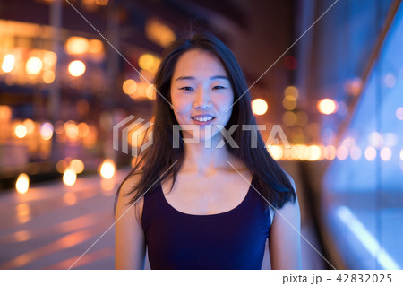 Portrait Of Beautiful Asian Woman Smiling Outdoors At Night 42832025