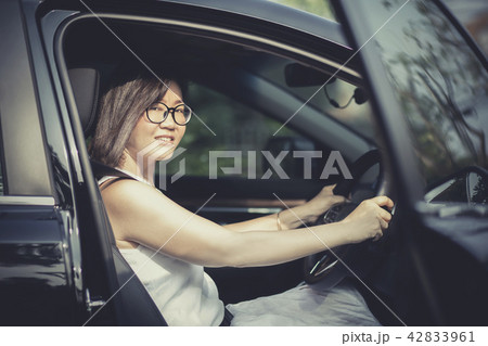 asian woman fasten car seat belt approach to drive asian woman fasten car seat belt approach to drive 42833961