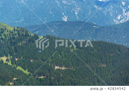 Blue helicopter flying over Alps Saalbach, Austria 42834542