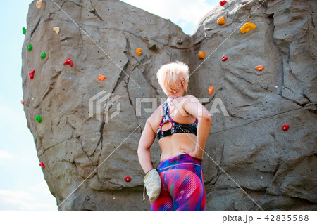 Photo from back of sporty girl climber with bag of soap against rock boulder Photo from back of sporty girl climber with bag of soap against rock boulder 42835588