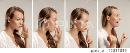 The young woman whispering a secret behind her hand The young woman whispering a secret behind her hand 42835836