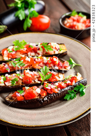 Baked eggplants with tomatoes, onion and garlic Baked eggplants with tomatoes, onion and garlic 42836323