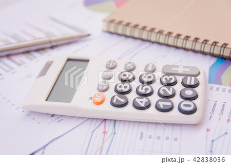 data analyzing with calculator, notebook and pen data analyzing with calculator, notebook and pen 42838036