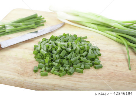 chopped green onions on white 42846194