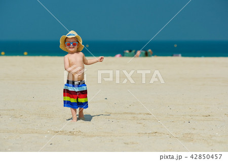 Two year old toddler boy running on beach 42850457