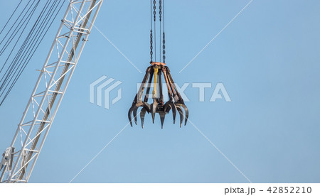 Big yellow construction crane on blue sky background 42852210