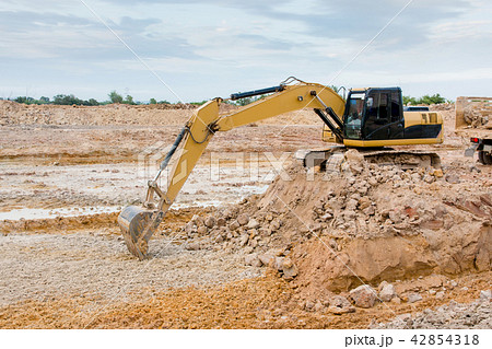 Yellow excavator machine working earth moving work Yellow excavator machine working earth moving work 42854318