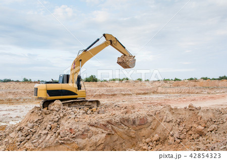 Yellow excavator machine working earth moving work 42854323