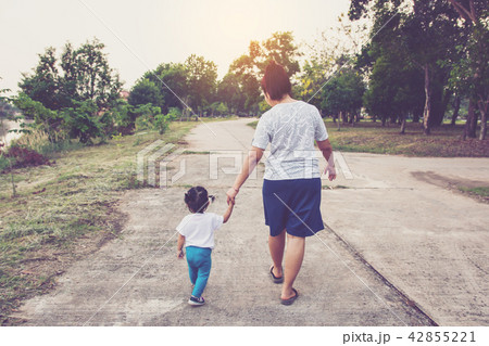 Mother holding a hand of his daughter walk  42855221