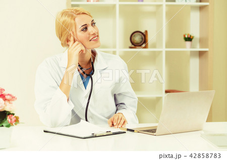 Young female doctor working in hospital office. 42858783