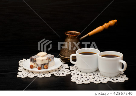 Two mugs of coffee, Turkish lokum with hazelnut Two mugs of coffee, Turkish lokum with hazelnut 42867240