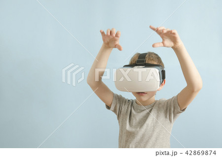 Boy in glasses of virtual reality. Blue background Boy in glasses of virtual reality. Blue background 42869874