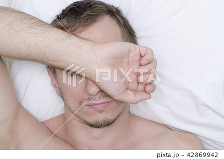 Man resting in mask for sleep. Stubble on his face 42869942