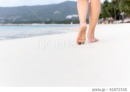 Woman walking on sand beach in tropical island. Woman walking on sand beach in tropical island. 42872338