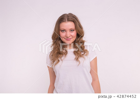 Fashion, style and people concept - pretty young woman dressed in white shirt over white background Fashion, style and people concept - pretty young woman dressed in white shirt over white background 42874452