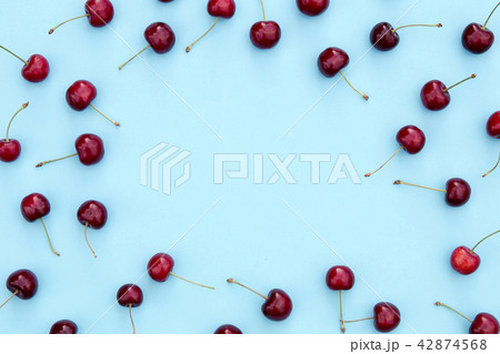 Fresh sweet cherries on blue background 42874568