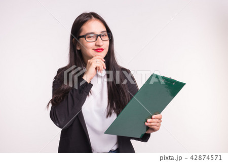 Asian young woman in glasses with paper folder, thinking out over white background 42874571