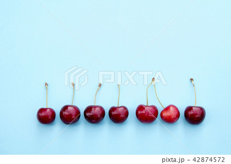 Fresh sweet cherries on blue background 42874572