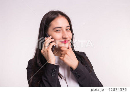 Beautiful asian girl in formal clothes with phone on white background 42874576
