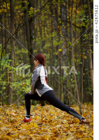Picture of sports fitness girl doing stretching exercises in fresh air 42875612
