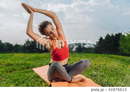 Dark-haired yoga woman stretching to the right side Dark-haired yoga woman stretching to the right side 42876613