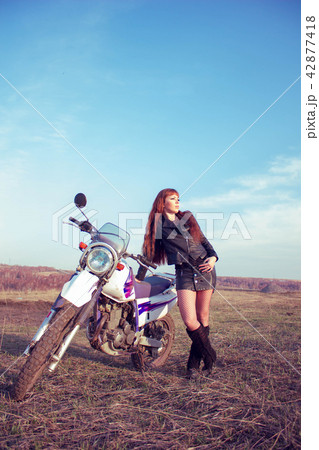 the girl next to the motorcycle 42877418