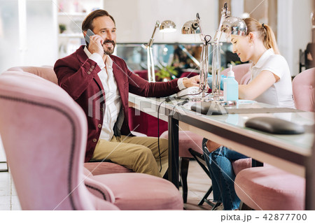 Professional female manicurist cutting male nails 42877700