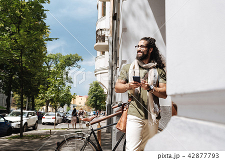 Positive joyful man looking at the street Positive joyful man looking at the street 42877793