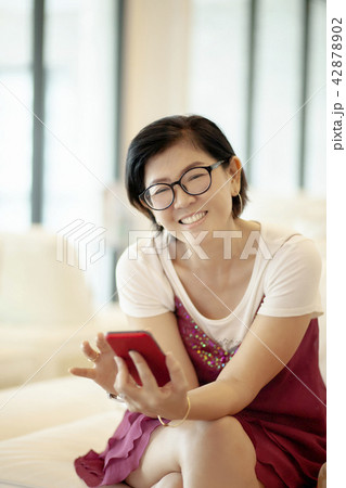 asian woman toothy smiling face in living room asian woman toothy smiling face in living room 42878902