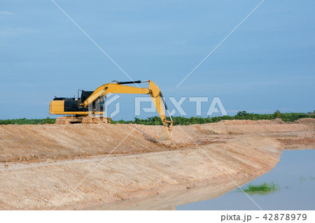Yellow excavator machine working earth moving work Yellow excavator machine working earth moving work 42878979