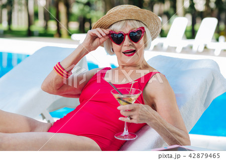 Funny cute grandmother drinking refreshing summer cocktail Funny cute grandmother drinking refreshing summer cocktail 42879465