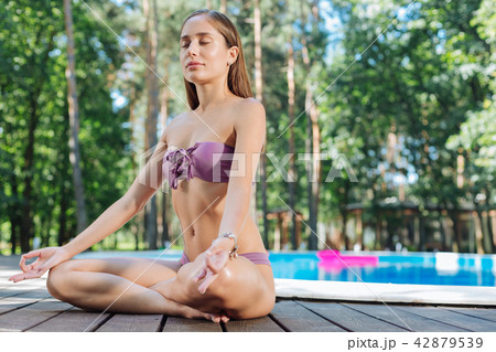 Woman pushing mindfulness away while meditating out Woman pushing mindfulness away while meditating out 42879539