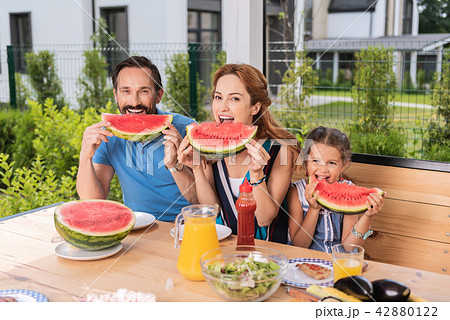 Happy positive family eating watermelons 42880122