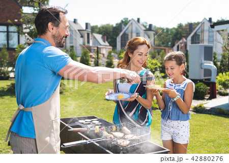 Cute young girl standing on the lawn Cute young girl standing on the lawn 42880276