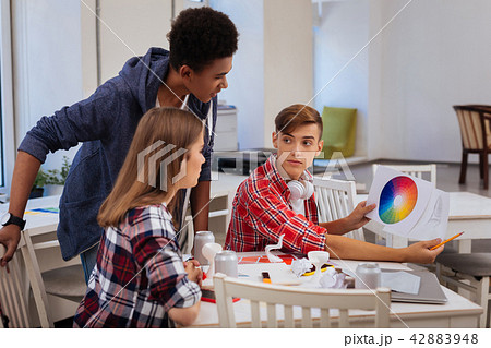 Blonde-haired student wondering about main color for his project 42883948