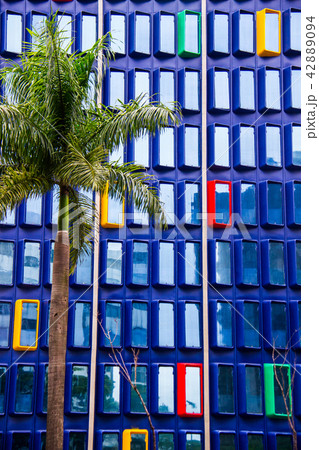 Blue building with red, yellow and green windows 42889094